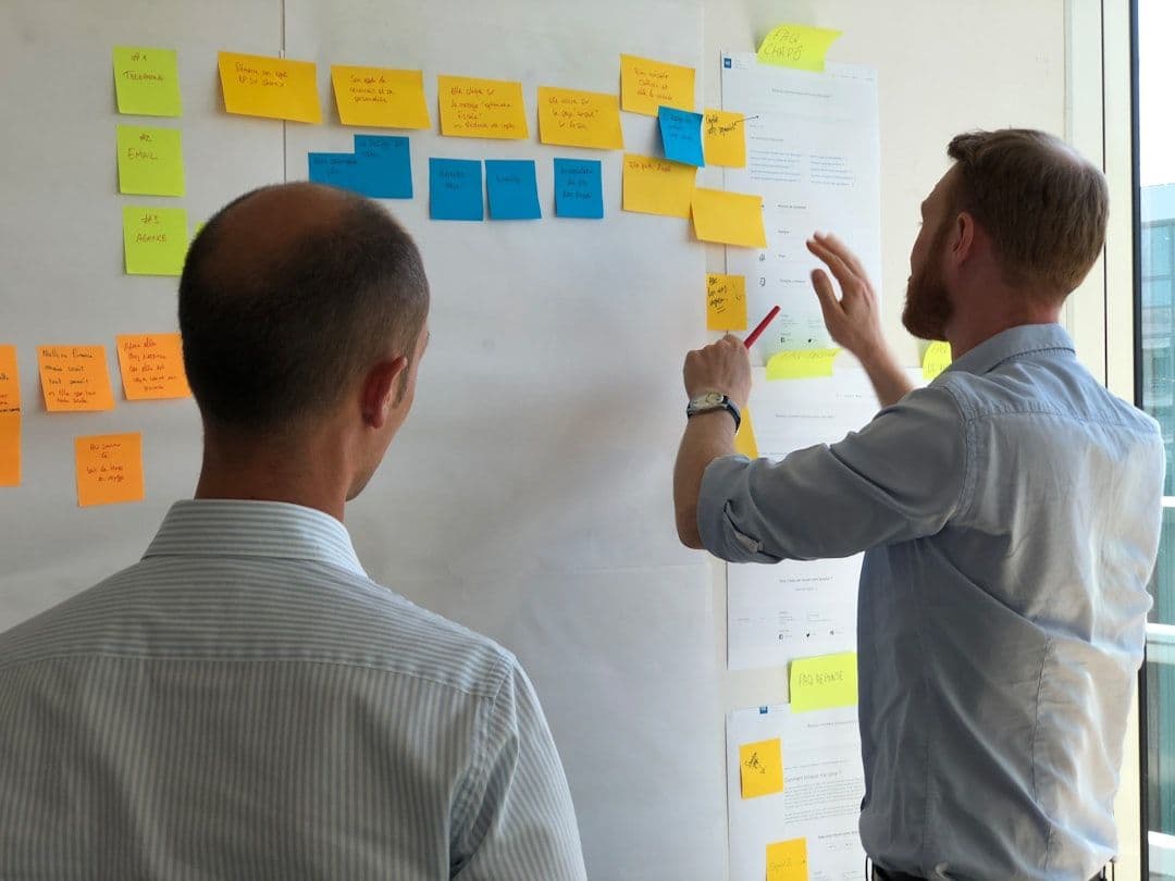 Project managers using software to manage workflows and team accountability