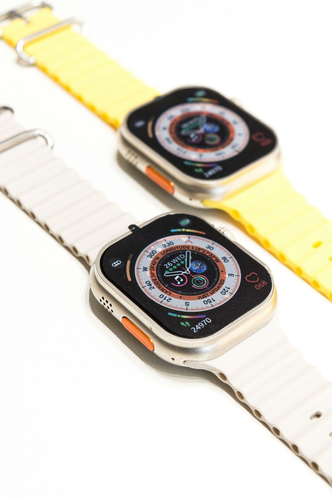Three smartwatches with customizable bands and colorful screens.