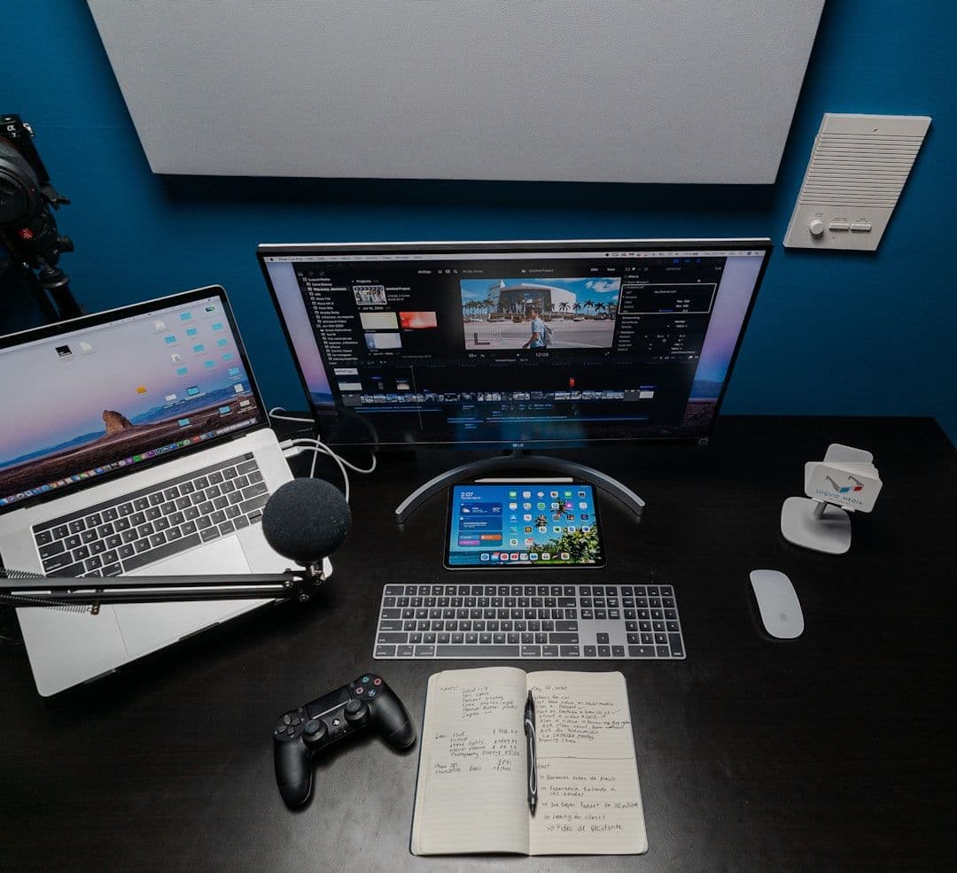 Two computer screens displaying legacy systems and modern apps being integrated.