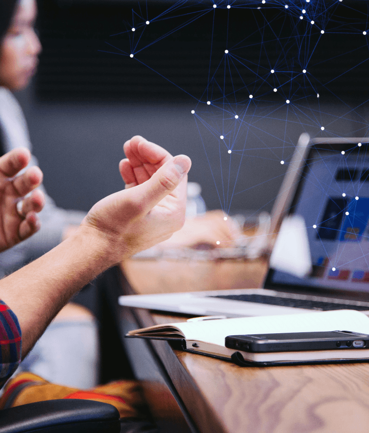 AI product design and UX illustration with team collaborating on laptops and digital network overlay, representing AI-driven user experience innovation and intelligent product design services.