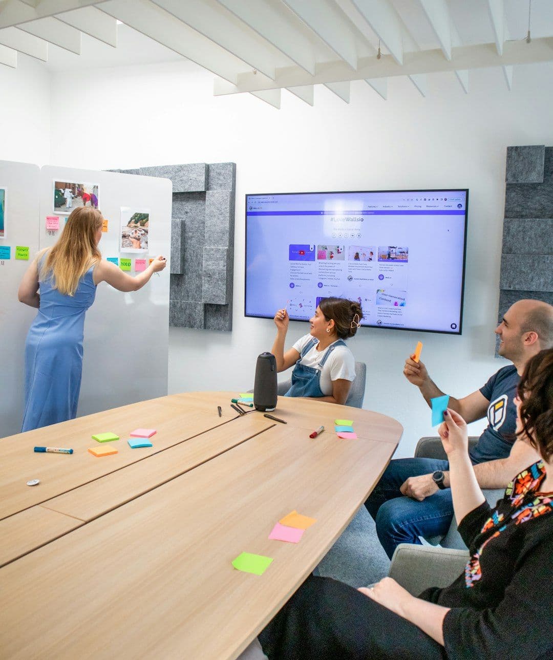 Innovative EdTech startup concept: team discussing using big screen