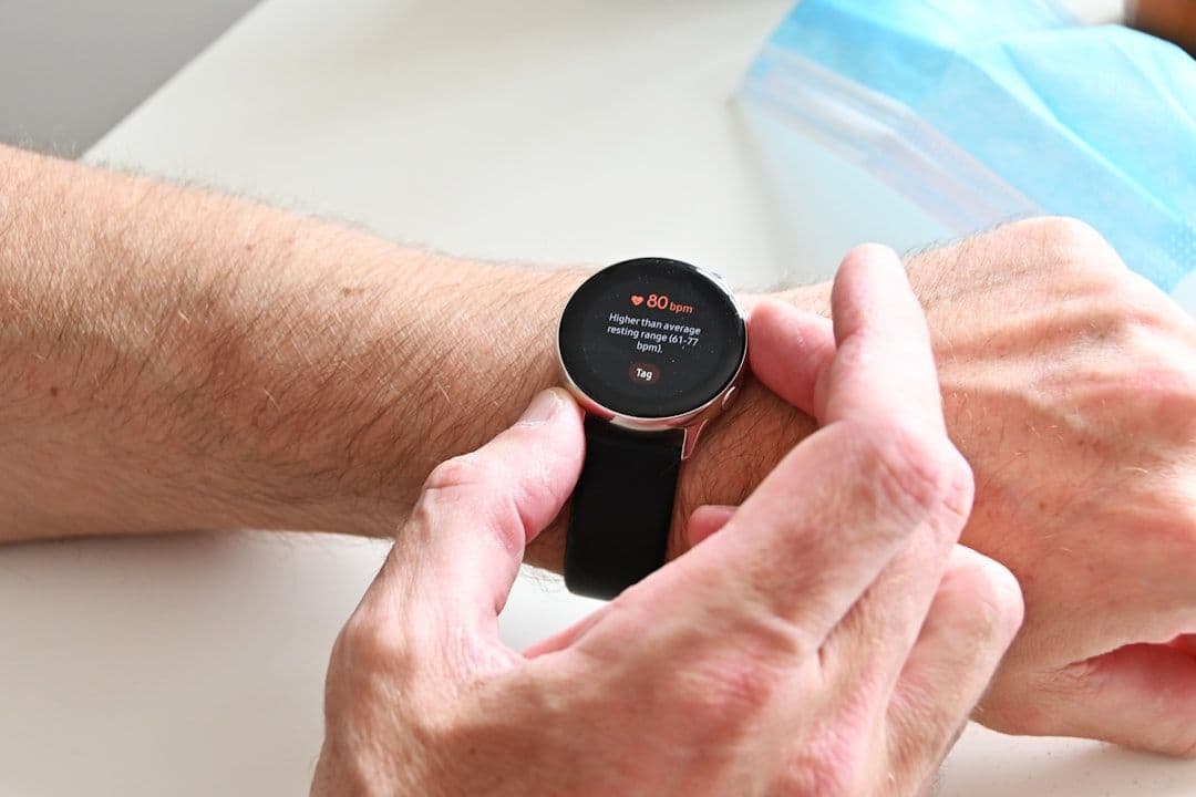 Smartwatch displaying patient vitals for remote monitoring in healthcare platform development