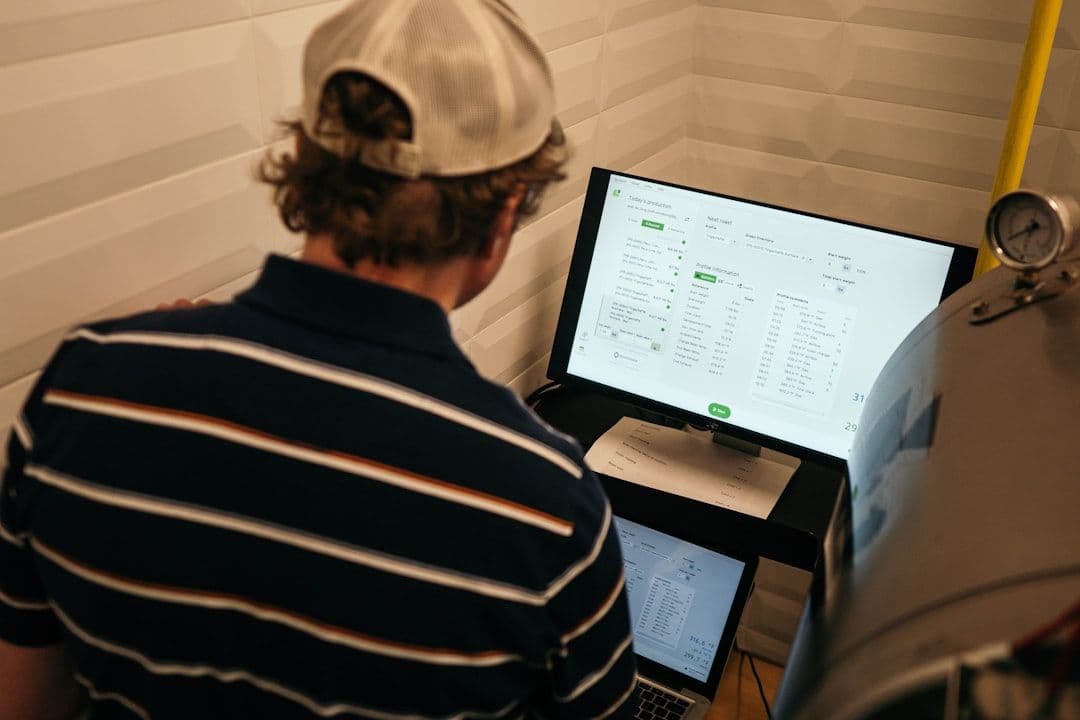 Business professionals at work on computers analyzing financial data.