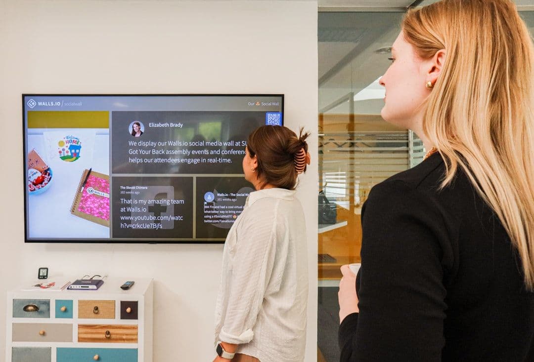 Corporate trainer evaluating employee progress using big screen