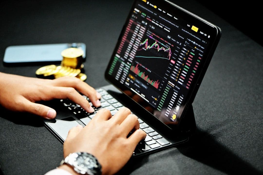 Three computer screens showing trading platform development for brokerage firms.