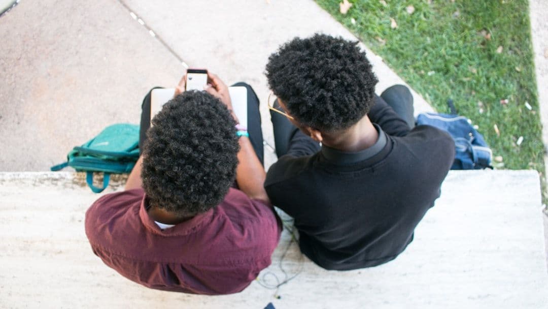 Diverse group of students using educational mobile app in classroom